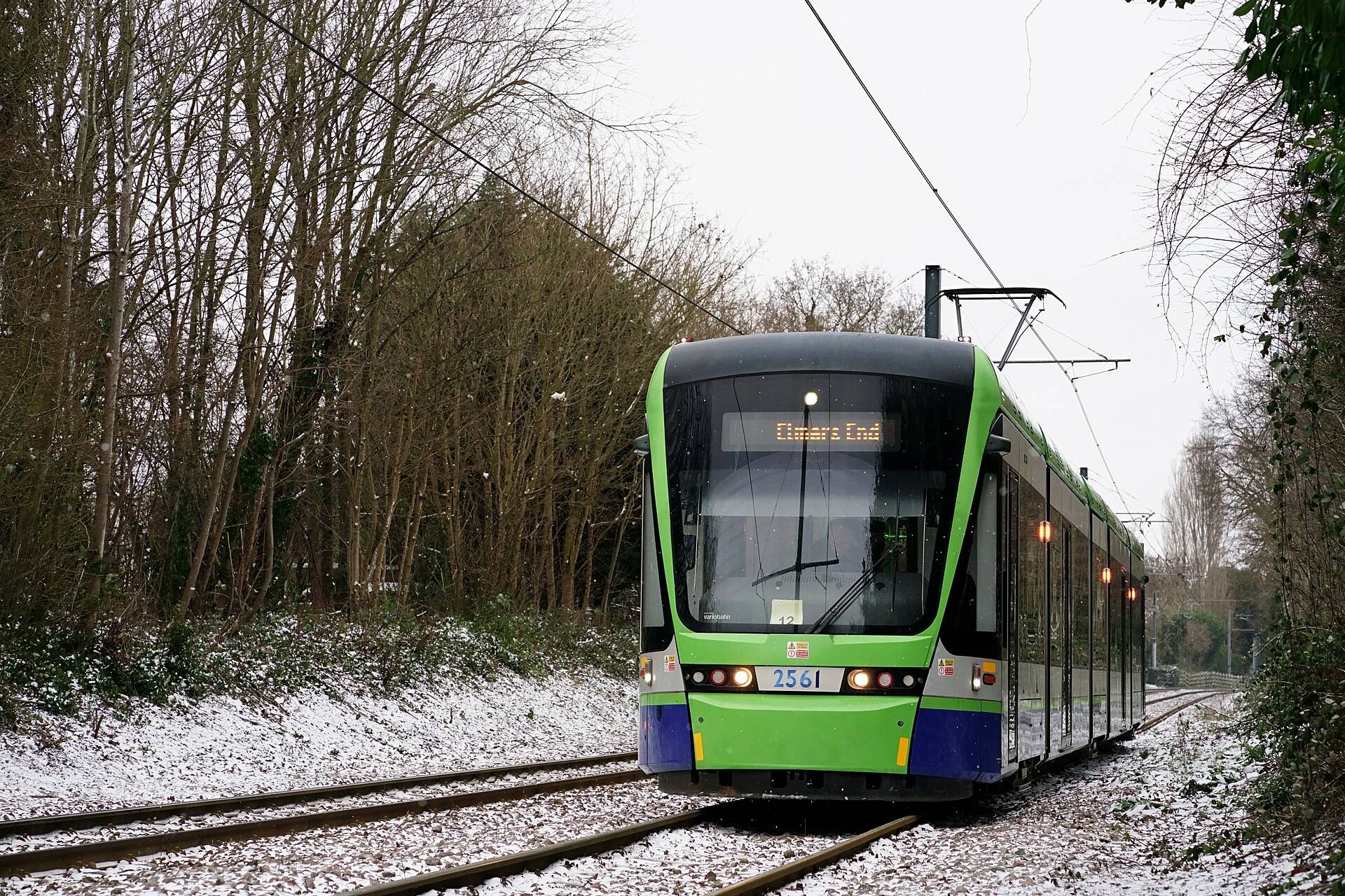 Green Croydon tram approaching the Addiscombe stop, part of the network our Croydon removals crews plan around